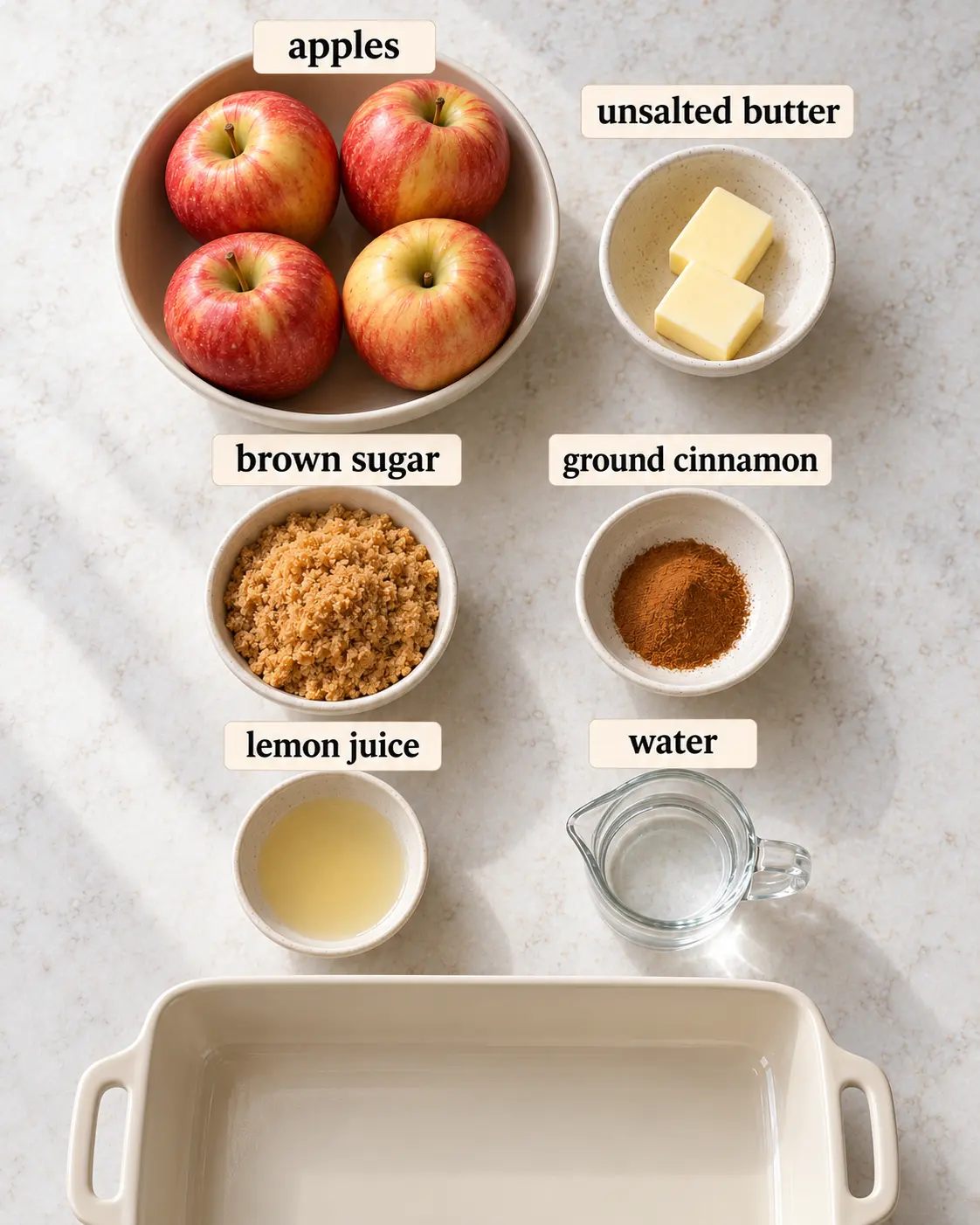apples, unsalted butter, brown sugar, ground cinnamon, lemon juice, water, arranged with ingredient labels before preparation.